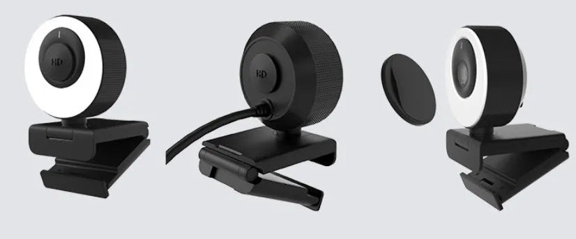 Black 1080p USB webcam on a desk with its magnetic privacy cover attached, showing the 1.7 metre USB cable.