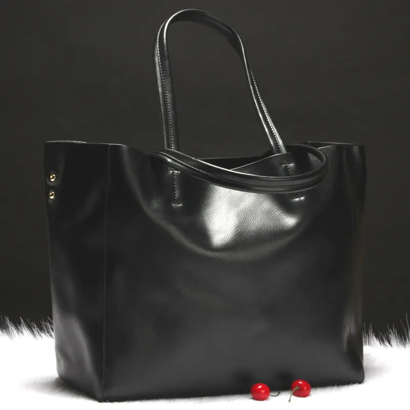 Women's structured cowhide leather shoulder bag shown in silver, with detachable strap.