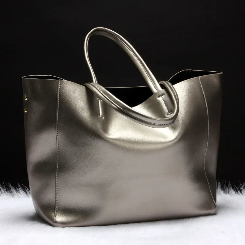 Women's structured cowhide leather shoulder bag shown in silver, with detachable strap.
