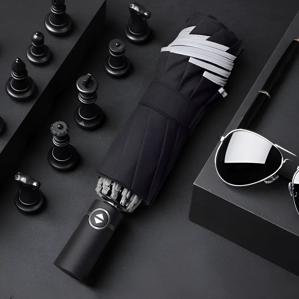 Black automatic reverse umbrella shown open, showcasing its 10-bone frame and folded compact size.