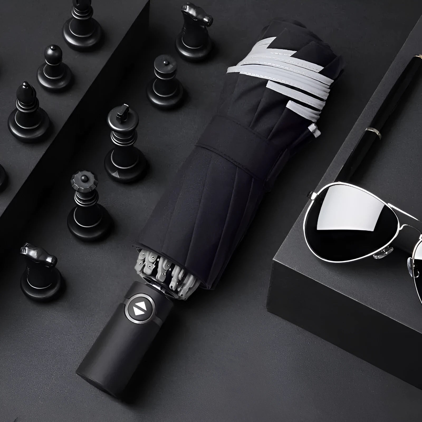 Black automatic reverse umbrella shown open, showcasing its 10-bone frame and folded compact size.