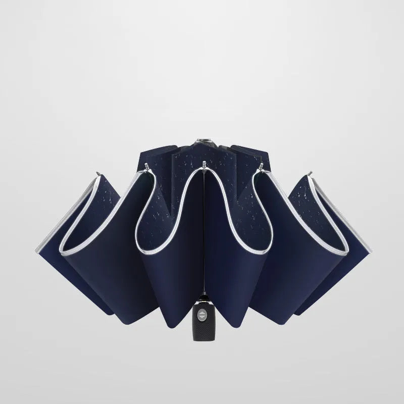 Black automatic reverse umbrella shown open, showcasing its 10-bone frame and folded compact size.
