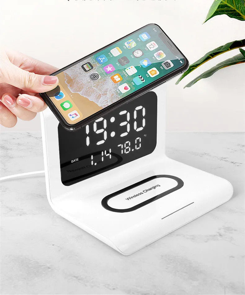 N1 model wireless charging alarm clock showing time, date and temperature display with phone charging on surface