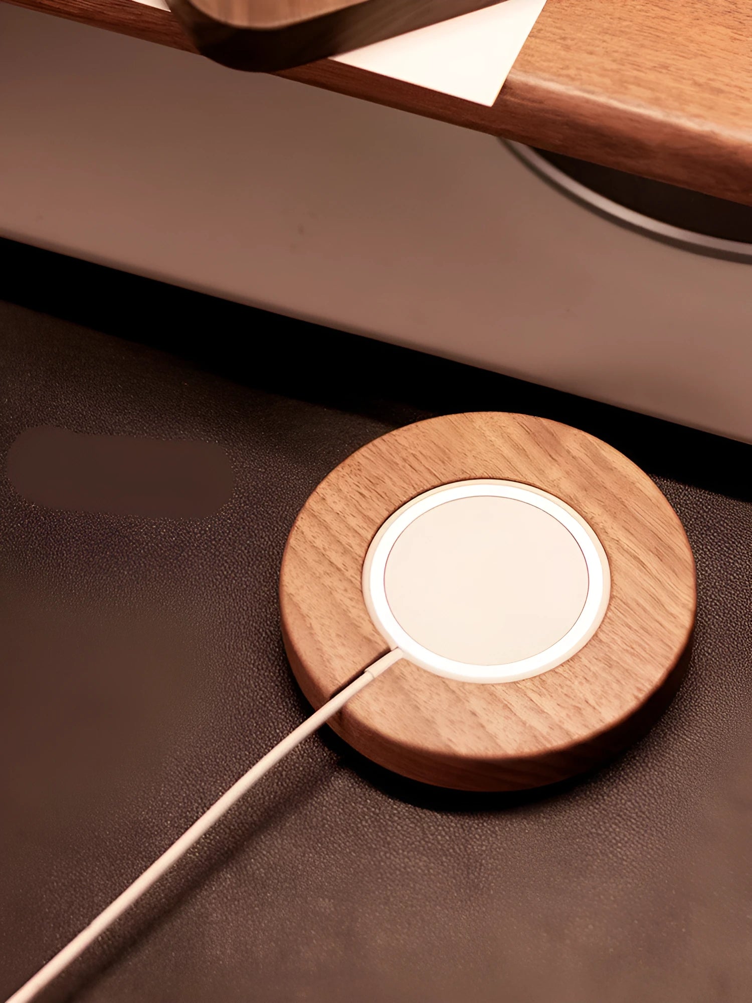 Walnut wood magnetic wireless charger bracket on desk with smartphone