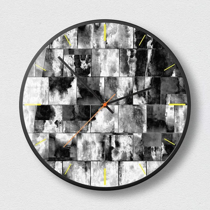 Round abstract art wall clock with metal case and black design, showing 12 and 14 inch size options.