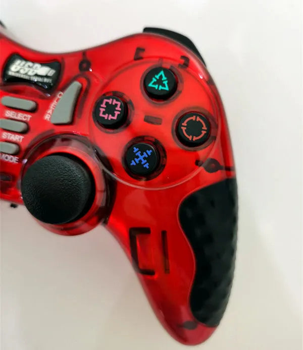 Red and grey wireless PC360 game controller with USB receiver on a desk