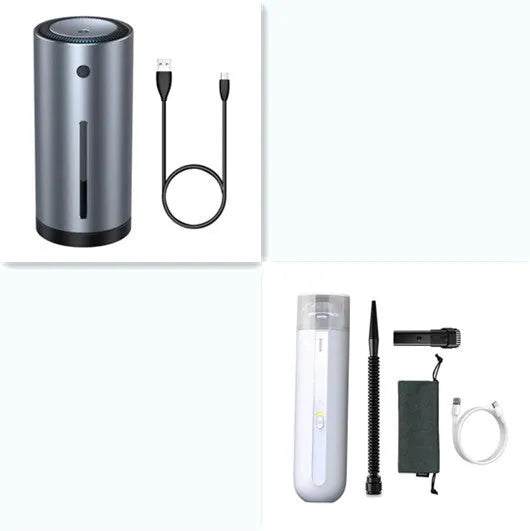 Black cordless handheld car vacuum cleaner with blowing hose attachment on a desktop.