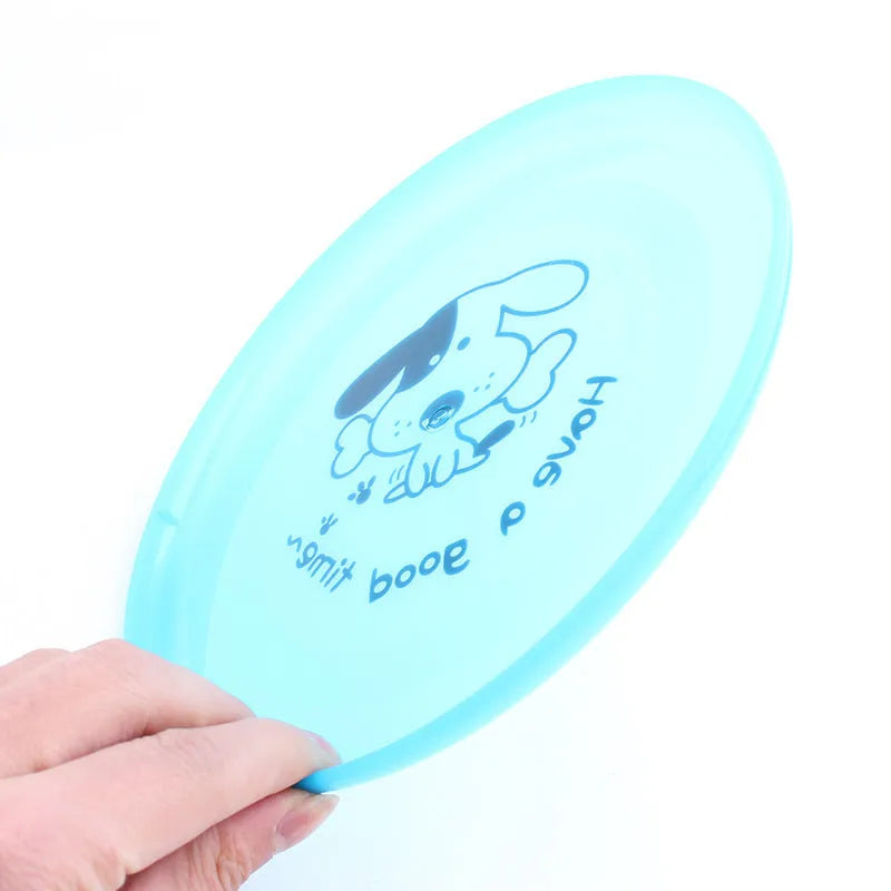 Silicone flying saucer dog toy 20cm diameter in random colour on grass for outdoor fetching play
