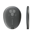 Black magnetic wireless charger with TYPE-C port on a desk.