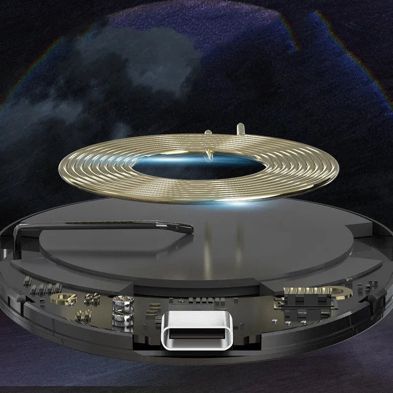 Black magnetic wireless charger with TYPE-C port on a desk.