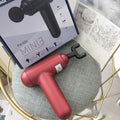 Black fascia gun massager with USB charging port for muscle relaxation