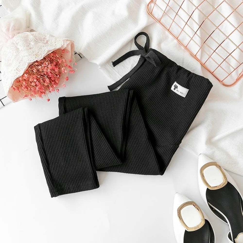 Black cotton maternity leggings with abdomen support, front view on model