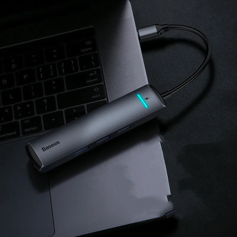 Mechanical Eye Type-C Docking Station in dark grey, compatible with MacBook and iPhone, on a desk