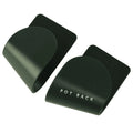 Black pot cover rack wall-mounted on white tile holding a metal saucepan lid