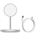 Black magnetic wireless charging stand holding an iPhone 12 Pro on a desk.