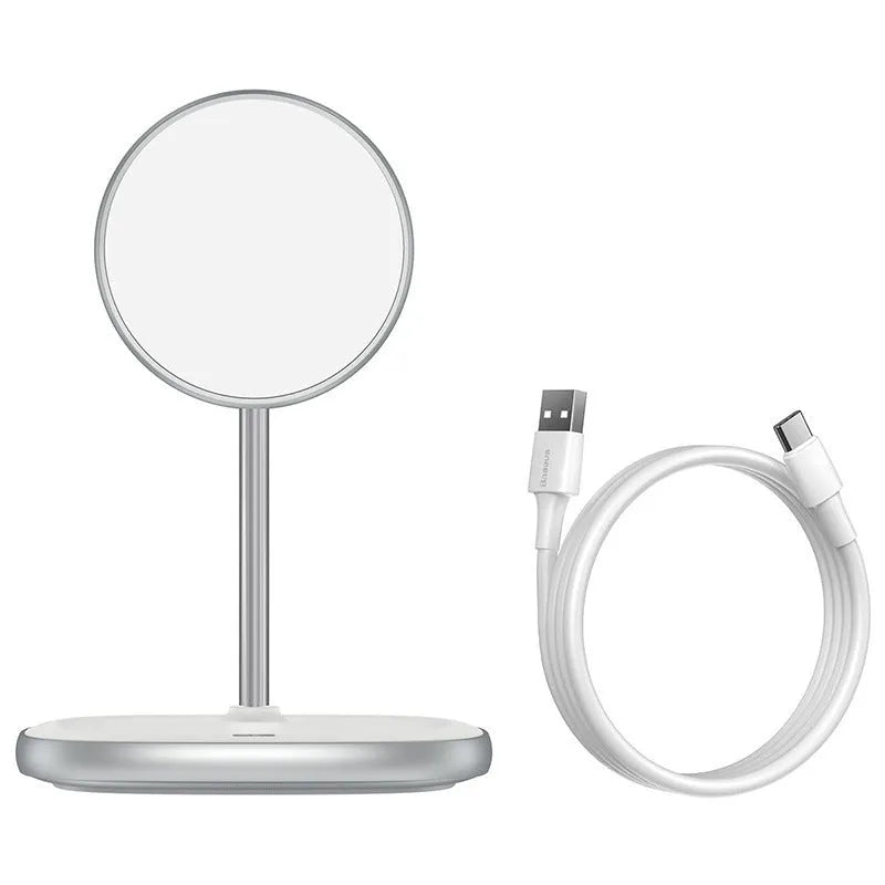 Black magnetic wireless charging stand holding an iPhone 12 Pro on a desk.