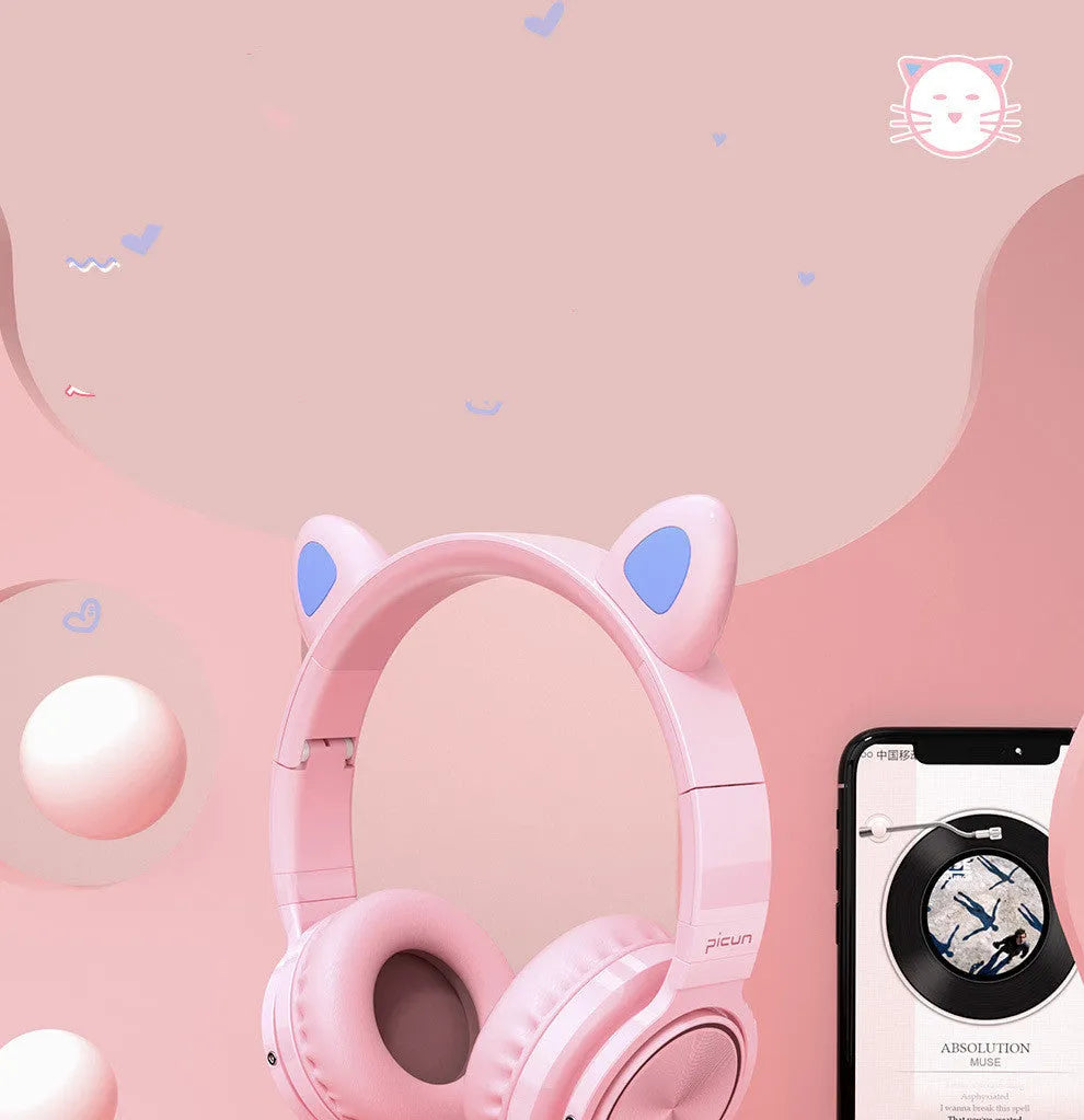 Pink and white Luminous Bluetooth wireless over-ear headset with microphone on a table.