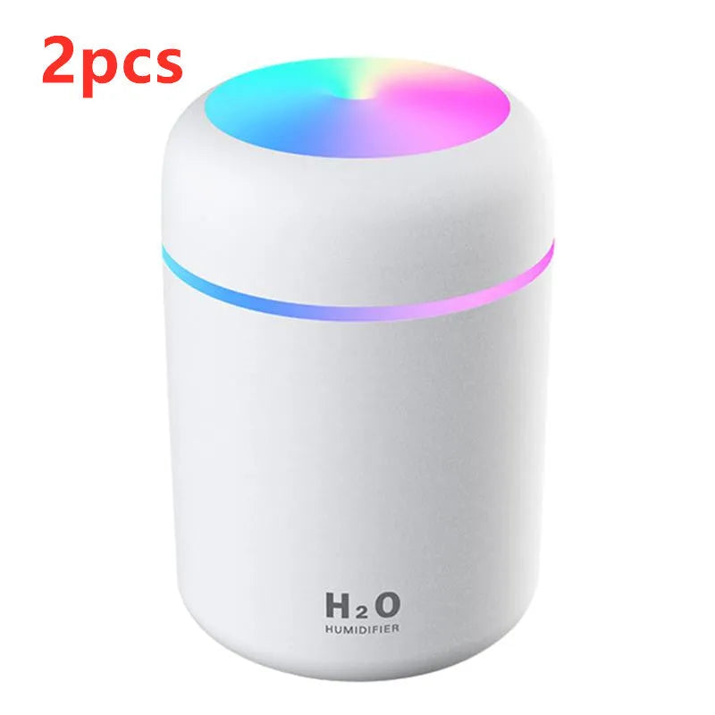 Pink USB desktop humidifier with colourful LED lights and 300ml water tank on wooden desk