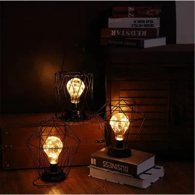 Minimalist hollow iron table lamp in wine glass or bottle design with warm white LED light