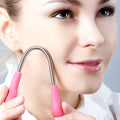 Pink facial hair remover with stainless steel spring and plastic handles, 19cm long, on a light background