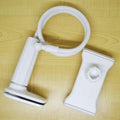Black bedside phone holder with long arm mounted on a wooden table