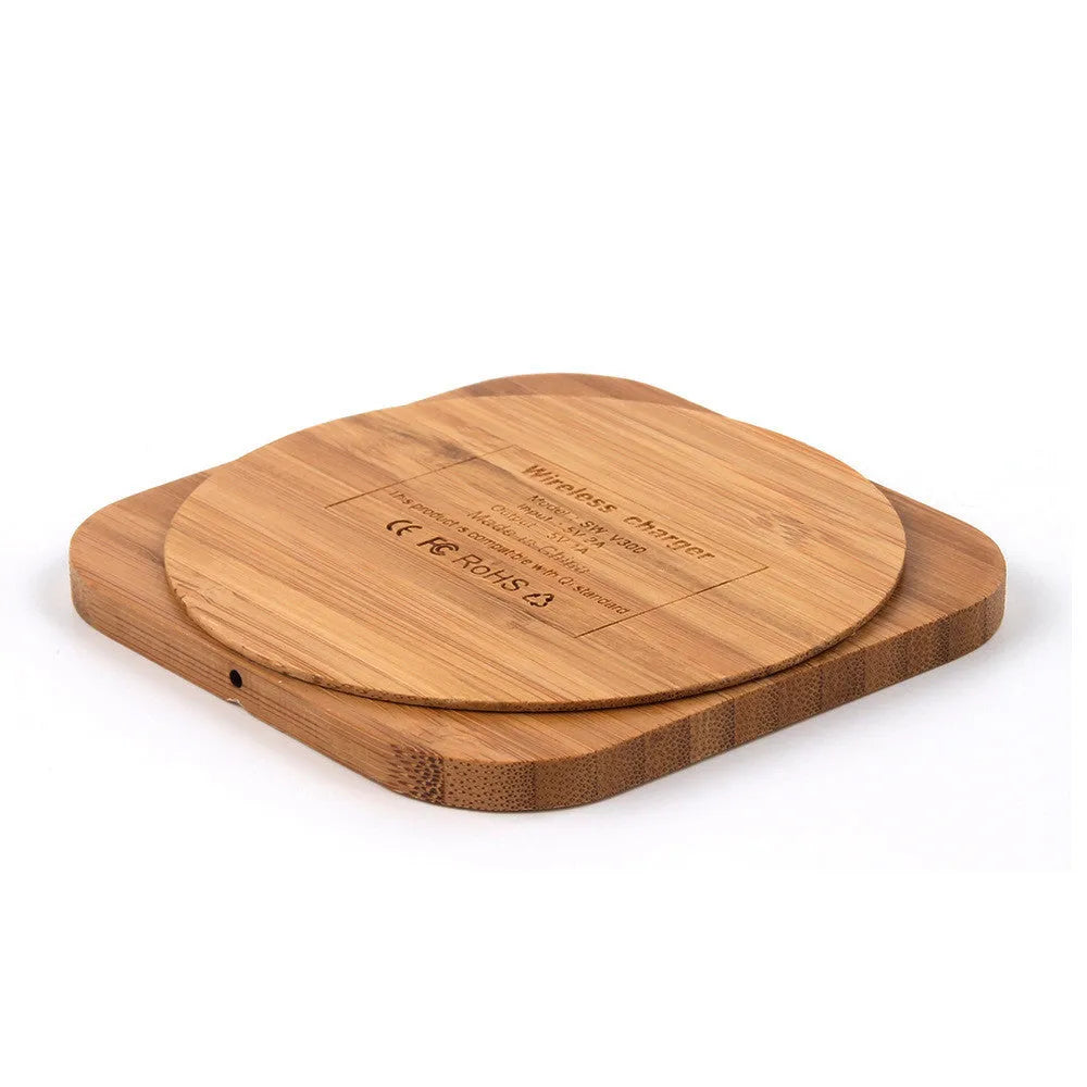 Square wooden bamboo 5W Qi wireless charging pad for smartphones on a table.