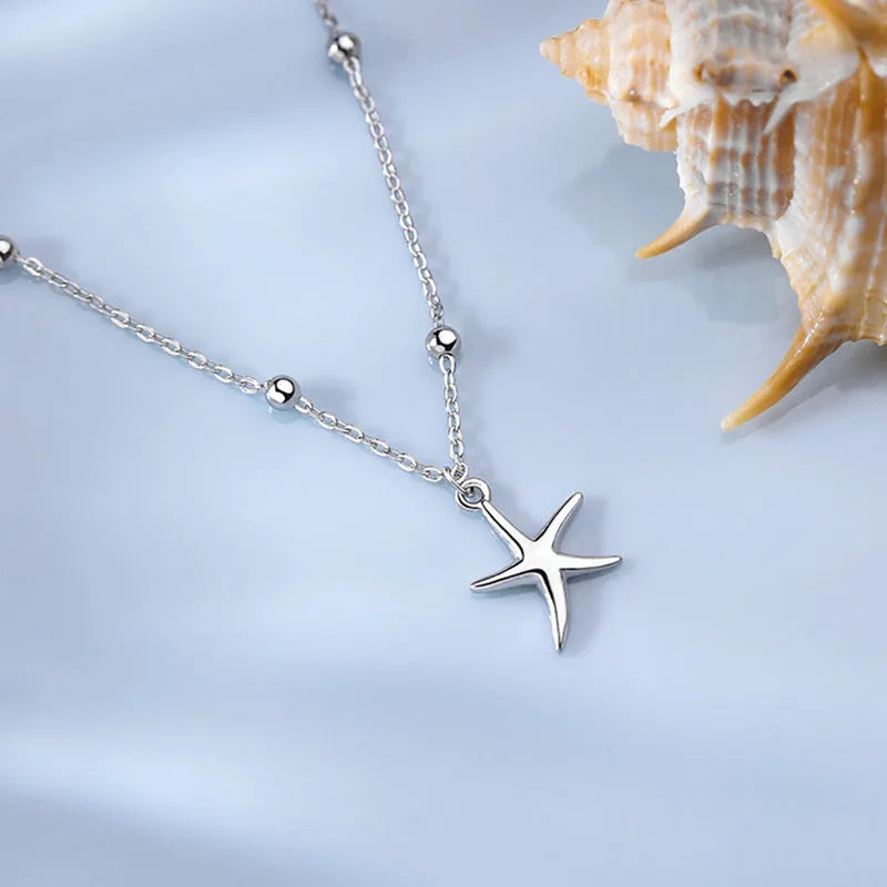 Silver starfish charm anklet on ankle showing S925 sterling silver construction and lobster clasp