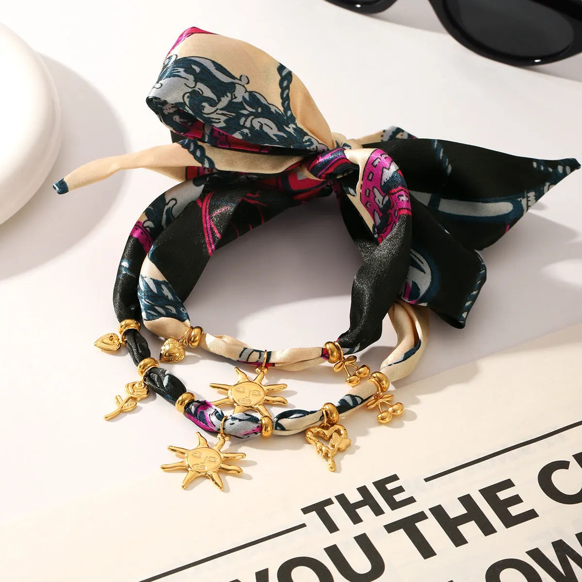 Children's stainless steel sunflower necklace and bracelet set in ins style on a light background