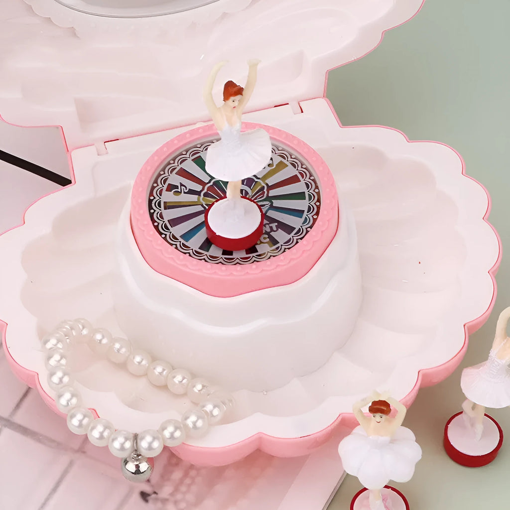 Plastic ballet girl music box in random colour, shows figure above shell, 160x130x155mm