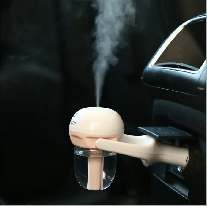 Compact blue car humidifier with rotating nozzle on car dashboard