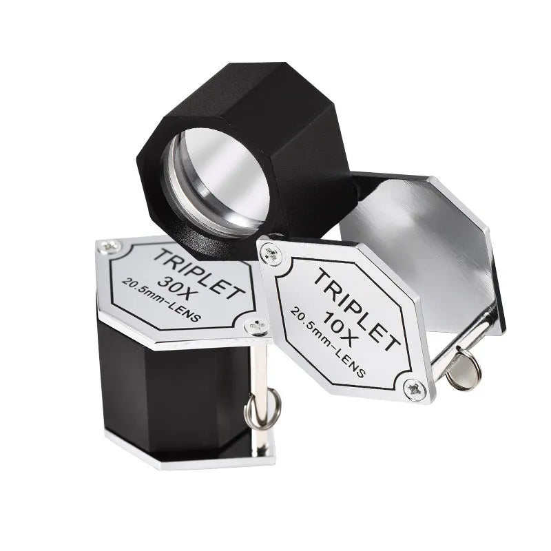 Handheld portable magnifying glass for jewellery and coin inspection with metal frame.