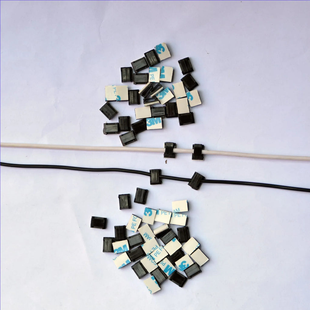 Black PA66 plastic automotive wire retaining clips for cable management in cars.