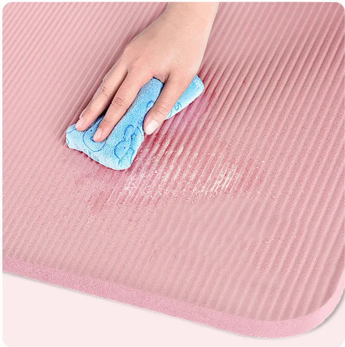 Widened blue TPE yoga mat 183x61cm on floor for home fitness stretching