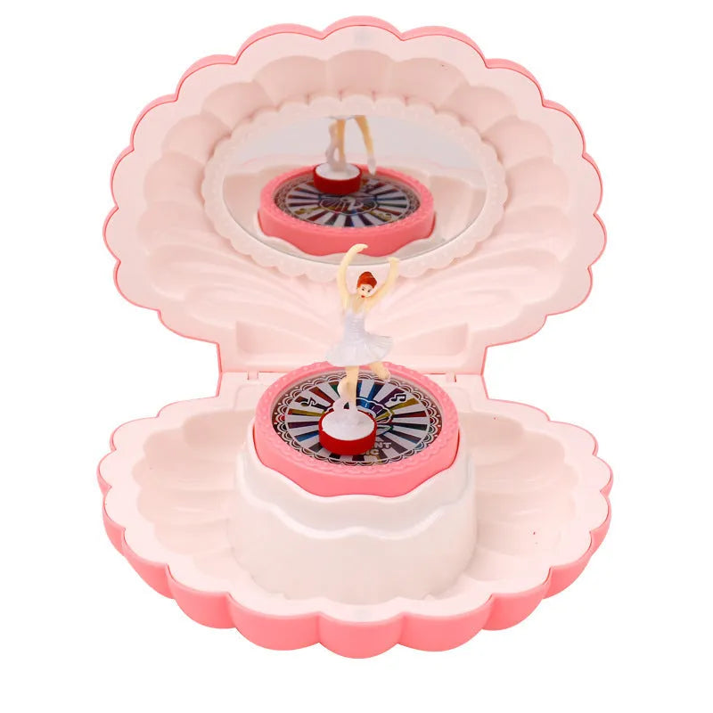 Plastic ballet girl music box in random colour, shows figure above shell, 160x130x155mm