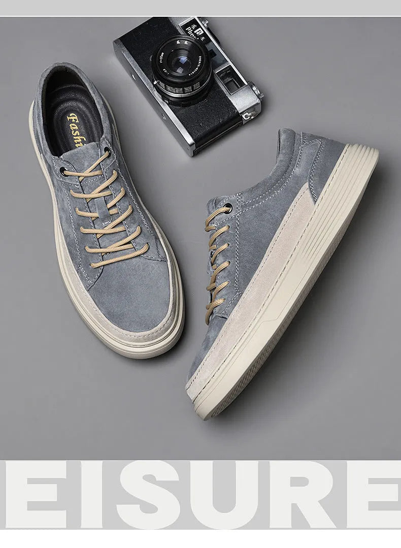 Men's grey pigskin leather casual skate shoes with flat rubber sole and lace-up front.