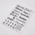Close-up of a transparent silicone craft stamp featuring vintage-style calendar icons on a digital table background.