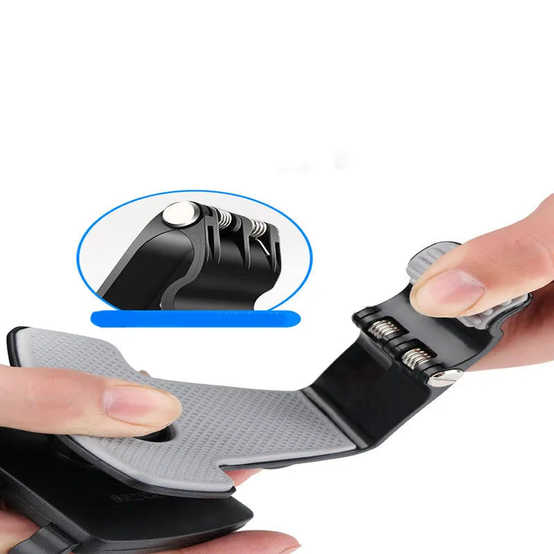 Black car phone holder mounted on dashboard with smartphone in clip