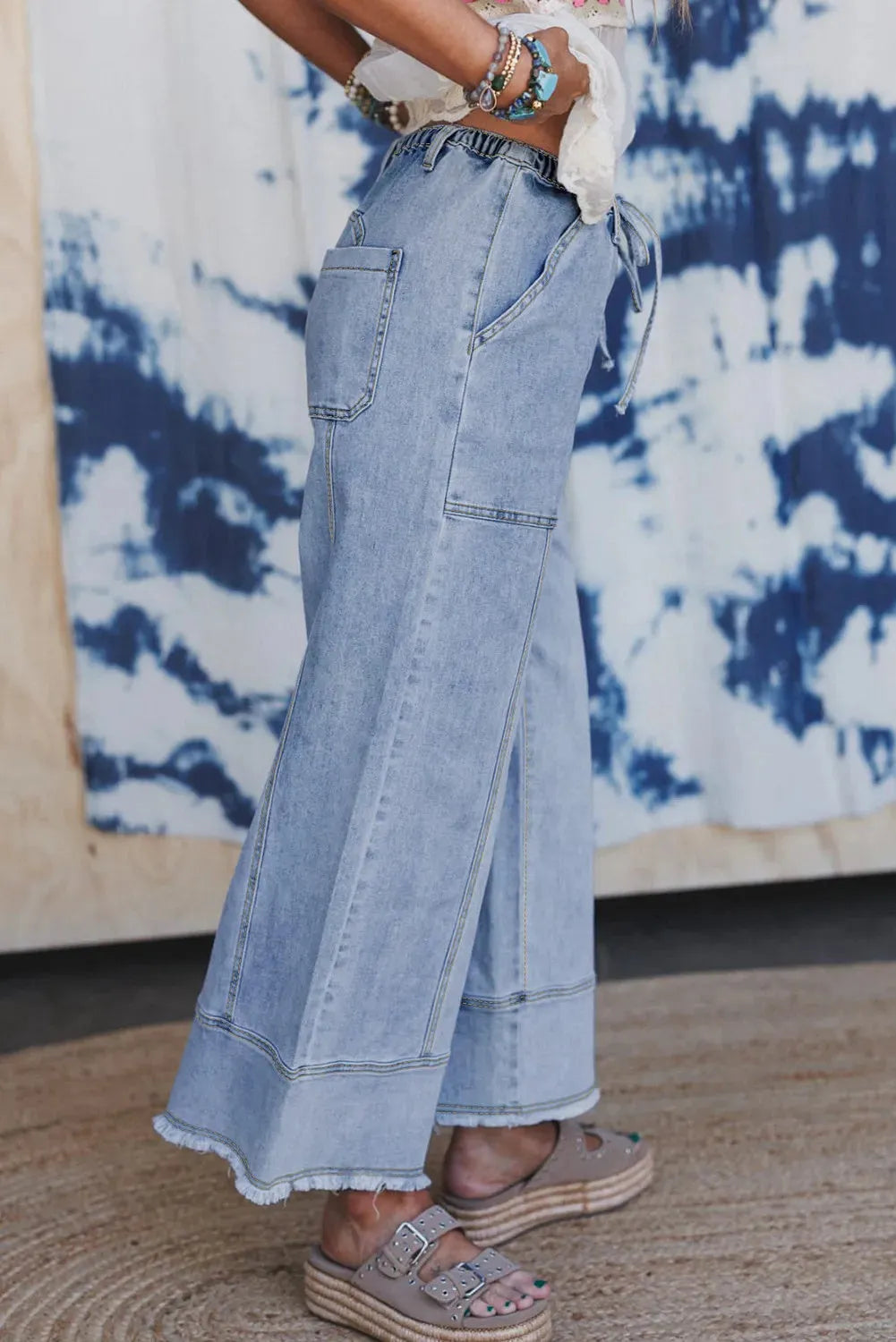 Beau blue women's wide leg denim trousers with a drawstring waist and raw hem seam detail