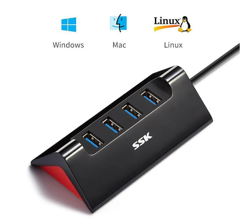 Black USB expansion dock with 4 ports and a Micro USB power input on a desk.