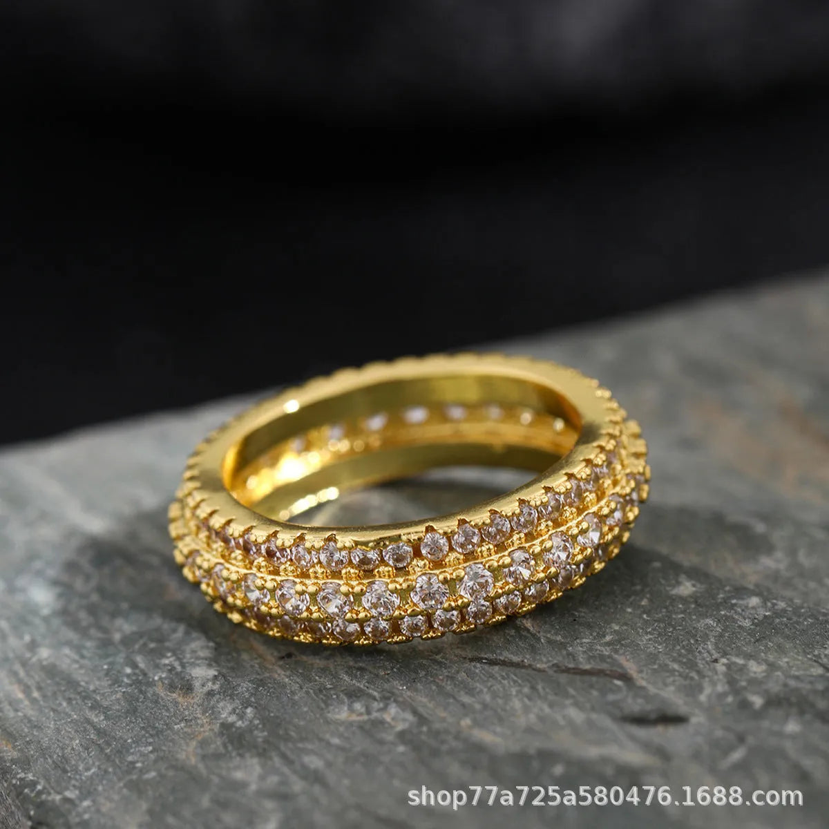 Geometric triangle design zircon inlay ring in copper, shown on a finger.