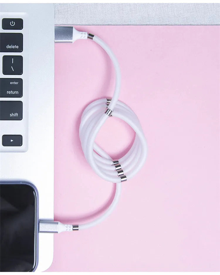 White magnetic nano data line with aluminium alloy joints and multiple connector heads on a desk