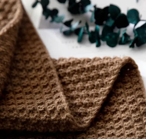 Nordic-style fringed knit acrylic blanket in a neutral colour, laid flat showing its 130x170cm size.