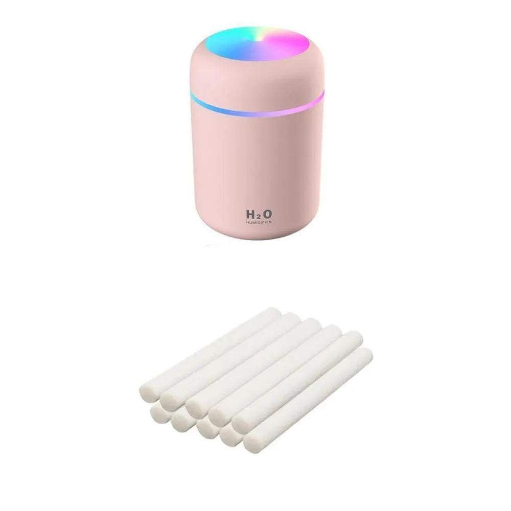 Pink USB desktop humidifier with colourful LED lights and 300ml water tank on wooden desk