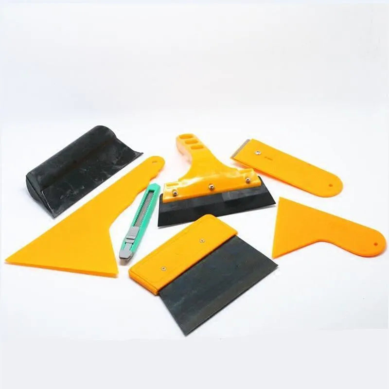 Seven-piece car film application tool set including scrapers, knives, and a pressing block on a white background.