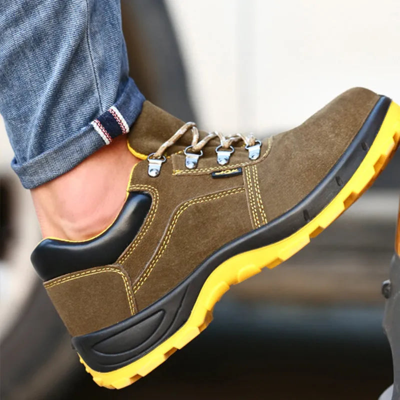 Bronze coloured leather safety boots with steel toe cap on a work site background
