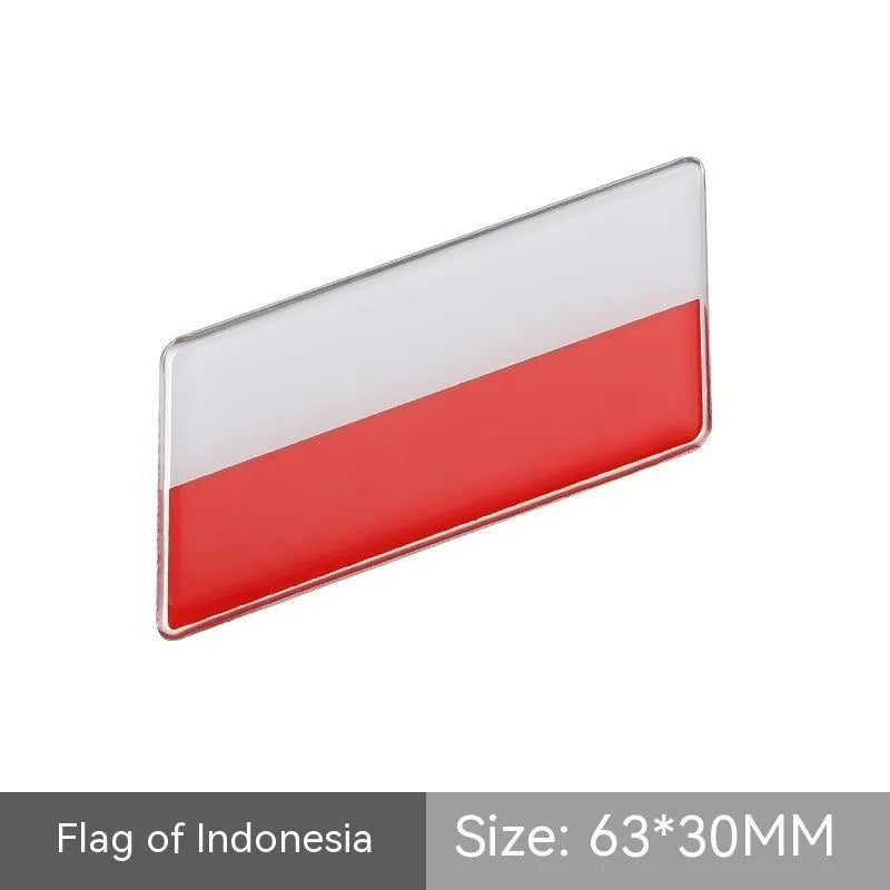 Aluminium parallelogram car sticker showing a national flag design, measuring 6.3 by 3 centimetres.