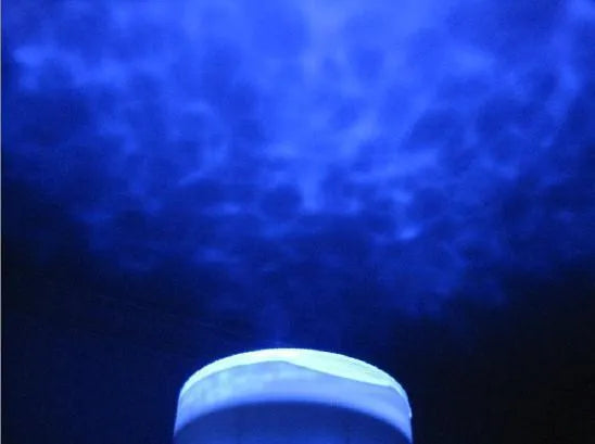 Blue ocean LED projection lamp showing a 2D underwater scene on a wall.
