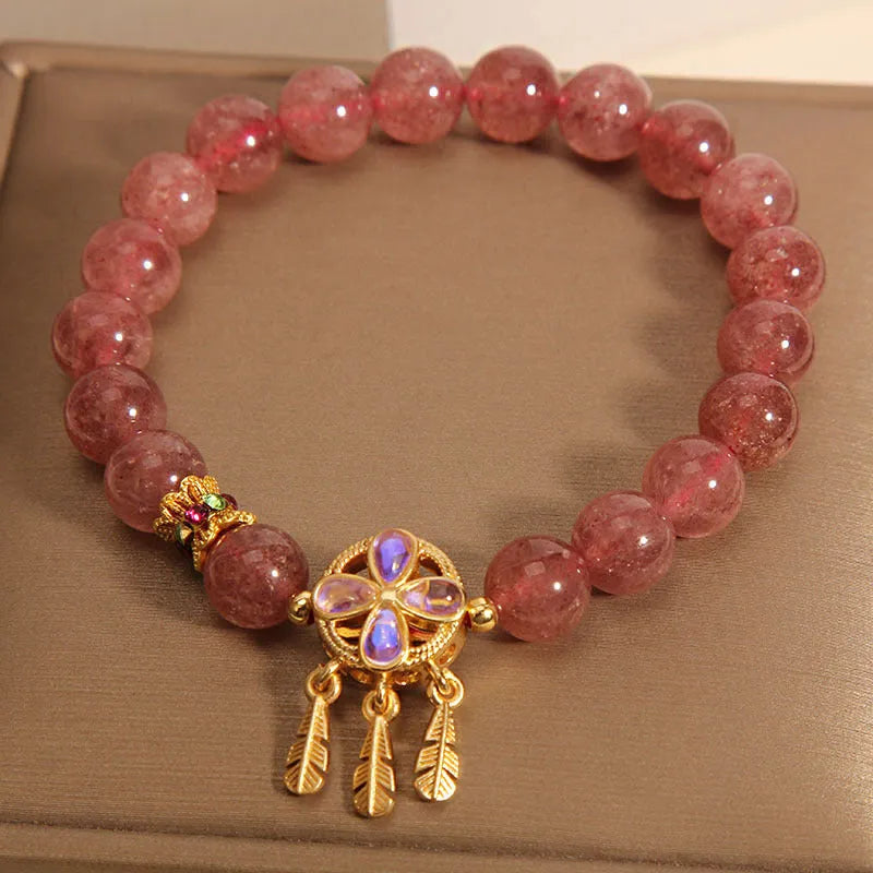 Women's bracelet with strawberry quartz dream catcher pendant on wrist
