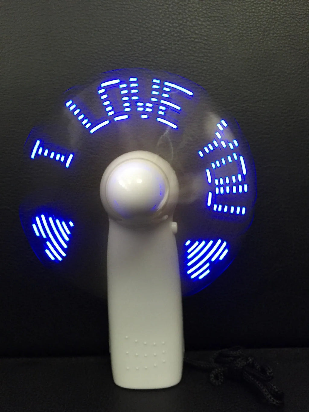 White handheld mini fan with a blue and red LED display showing 'I Love You' and a heart pattern.