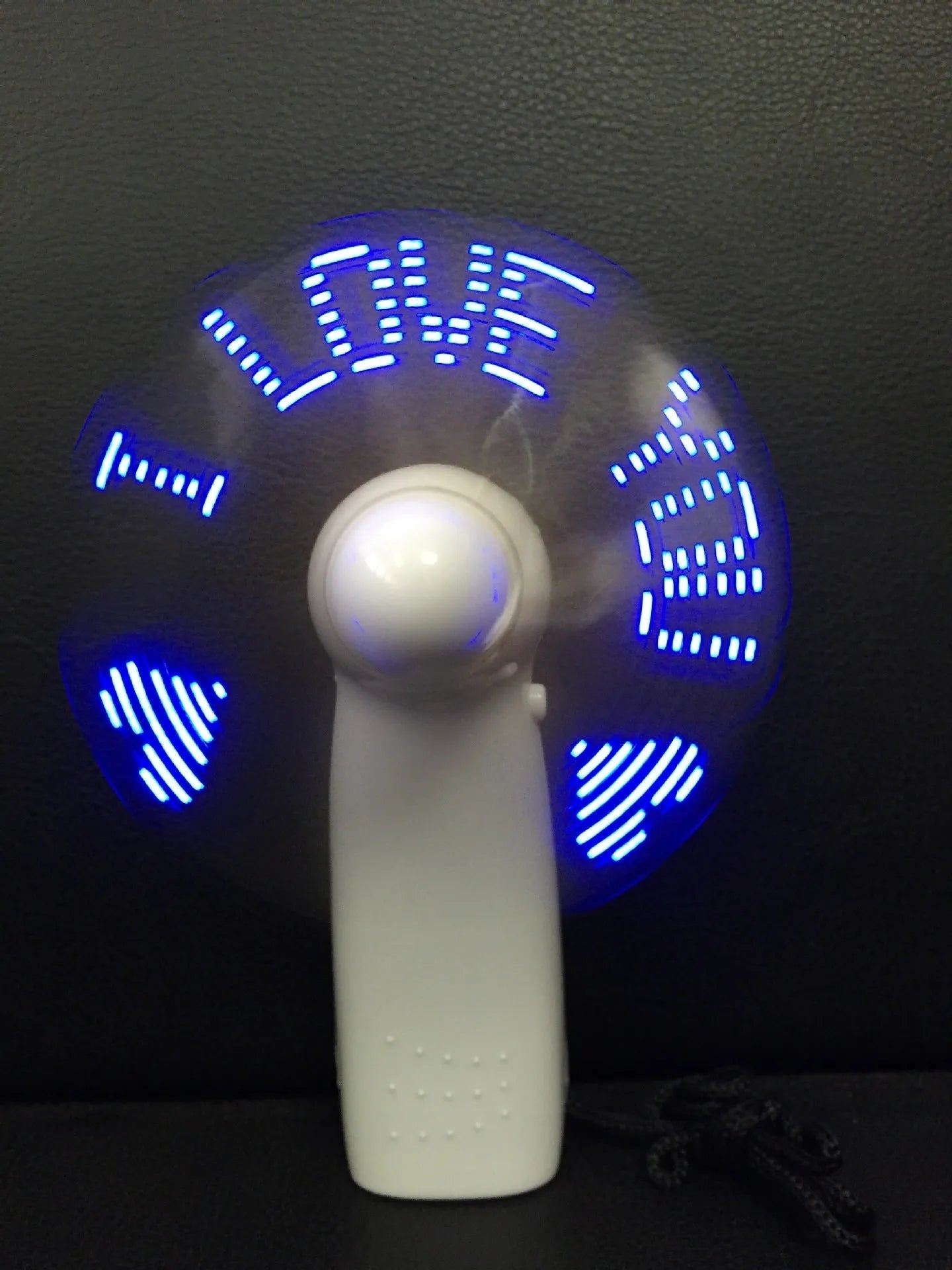 White handheld mini fan with a blue and red LED display showing 'I Love You' and a heart pattern.